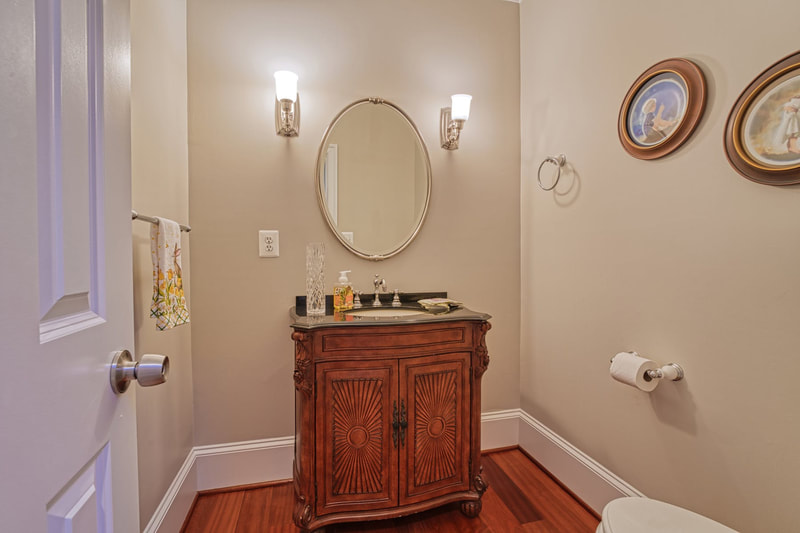 The main level of the house has a nice sized powder room with hardwood floor