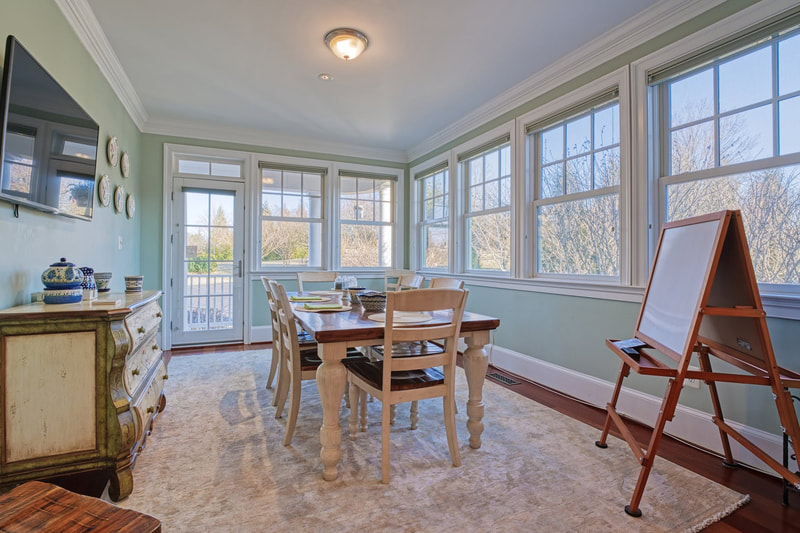 Off of the kitchen is a large breakfast room surrounded by windows to the outside