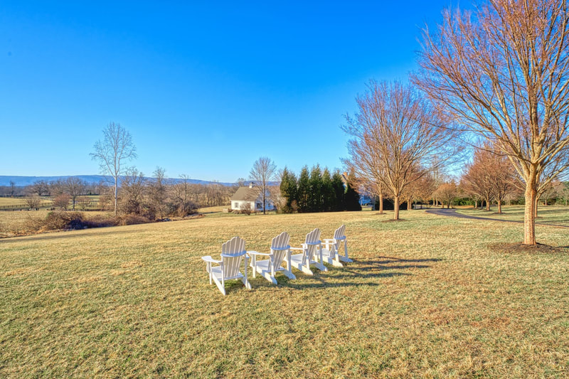 There are four Adirondack chairs up the hill facing the Blue Ridge Mountains of Virginia