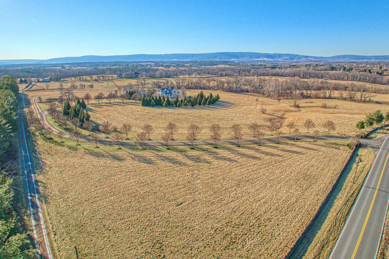This drone photograph nicely shows the meandering driveway from St. Louis Road to the house with the Blue Ridge Mountains in the background