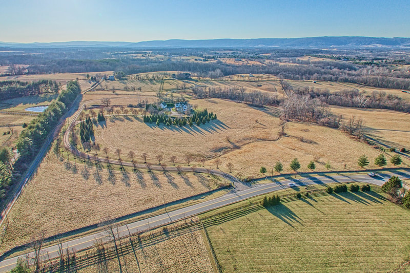 This drone photograph nicely shows the meandering driveway from St. Louis Road to the house with the Blue Ridge Mountains in the background